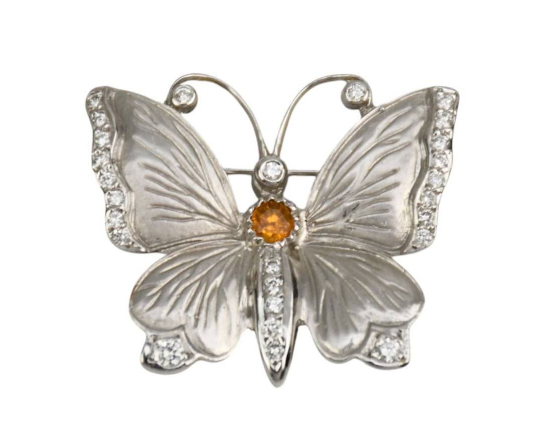18K White Gold Butterfly Brooch. With diamond accents, 1" x 1.25" wt.10.3 grams Marked MCD 18k: 18K White Gold Butterfly Brooch. With diamond accents, 1" x 1.25" wt.10.3 grams Marked MCD 18k