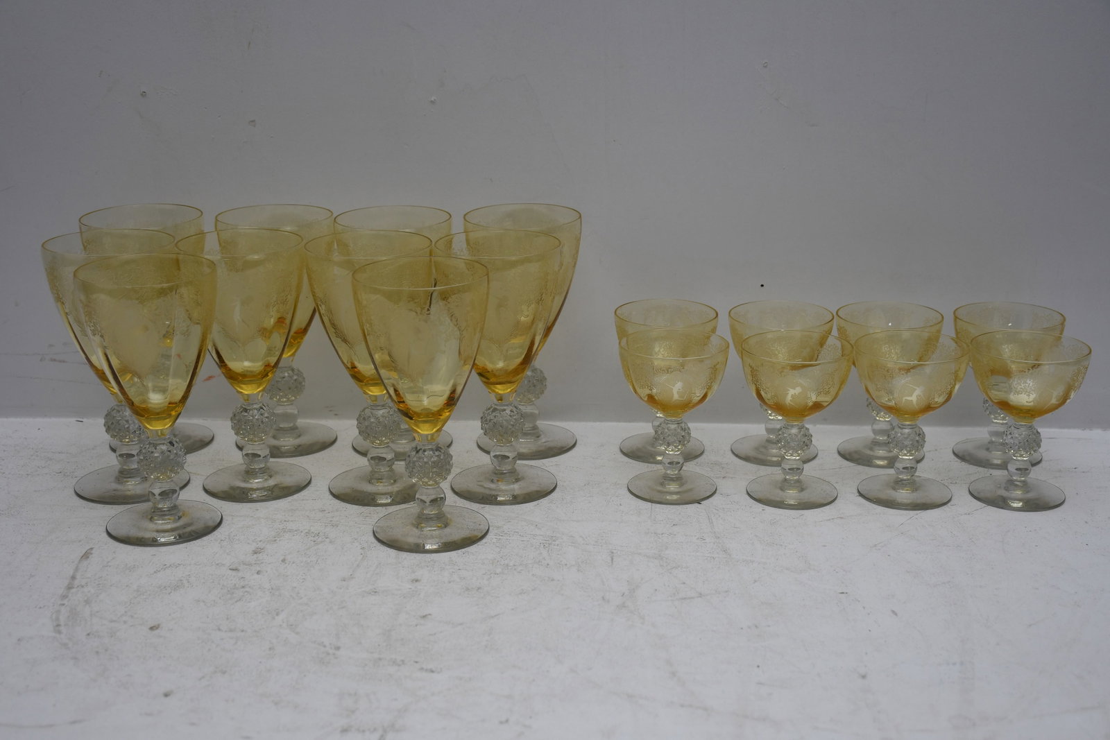 18 Yellow Topaz glasses with acid etches figural designs 10 water goblets (7" h x 3.25" dia) and 8 c (1 of 8)