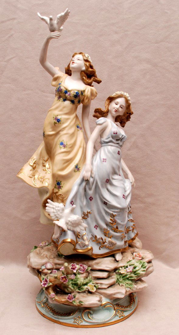 2 porcelain female figures with doves, on rock style: 2 porcelain female figures with doves, on rock style platform base, cross swords mark, 21"h