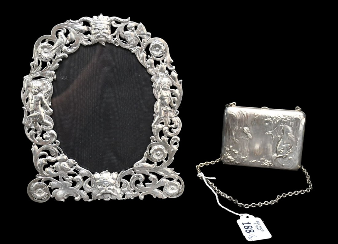 Continental Silver Frame, Reticulated with Mask at Top and Bottom (8"H x 7"w) AND Sterling Case With: Continental Silver Frame, Reticulated with Mask at Top and Bottom (8"H x 7"w) AND Sterling Case With Chain Depicting Dolphins and Fish (4" x 3")