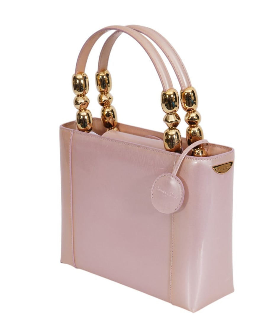Vintage Christian Dior pink Maris Pearl/Malice Tote original release around 1997-1999. material is a: Vintage Christian Dior pink Maris Pearl/Malice Tote original release around 1997-1999. material is a pink patent leather with a structured geometric tote shape. Round gold metallic beads on handles. T