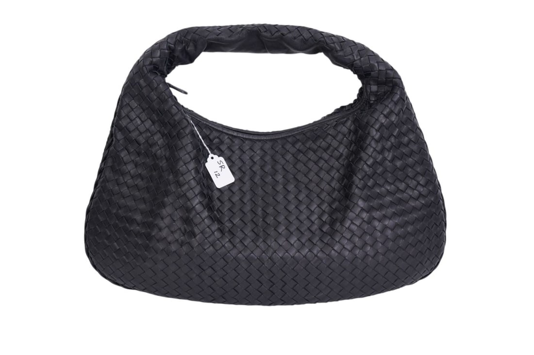 Bottega Veneta Black Hobo bag featuring its Intrecciato woven leather design. A slouchy crescent: Bottega Veneta Black Hobo bag featuring its Intrecciato woven leather design. A slouchy crescent silhouette and seamless top handle. This bag is in excellent condition and very mild use. No dust bag