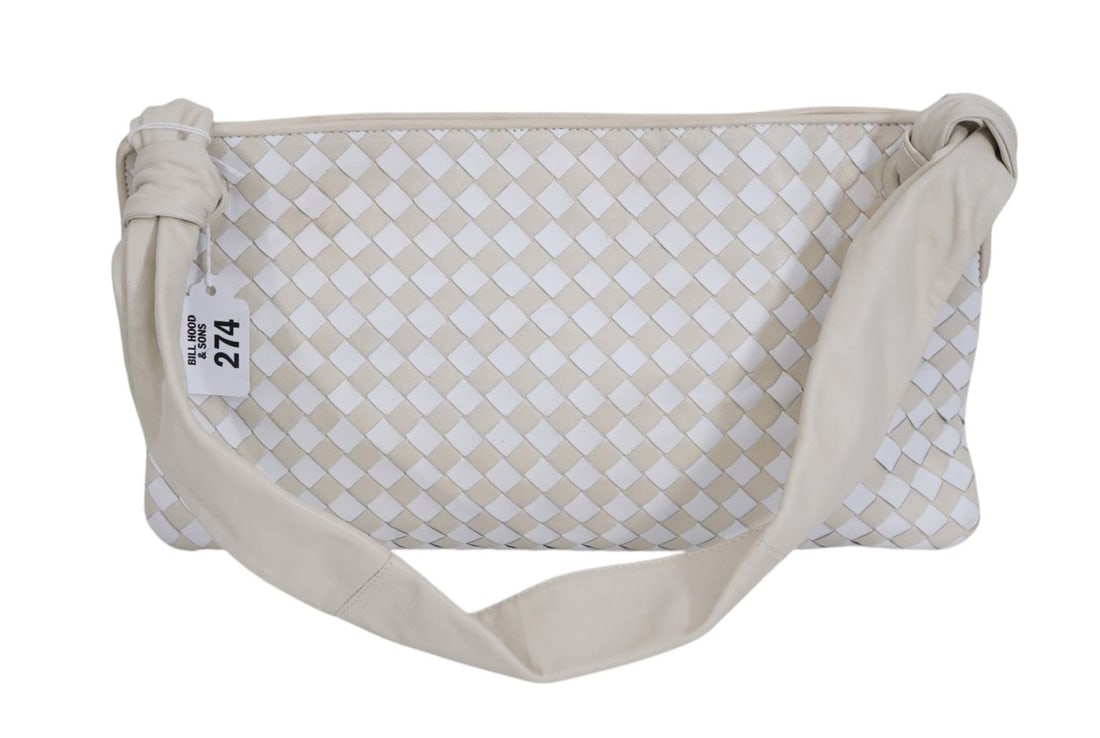 Vintage Bottega Veneta bi-color Intrecciato woven leather pouch bag, featuring a distinct cream and: Vintage Bottega Veneta bi-color Intrecciato woven leather pouch bag, featuring a distinct cream and beige woven pattern. Soft leather shoulder strap with asymmetrical style. Purse has very soft butter