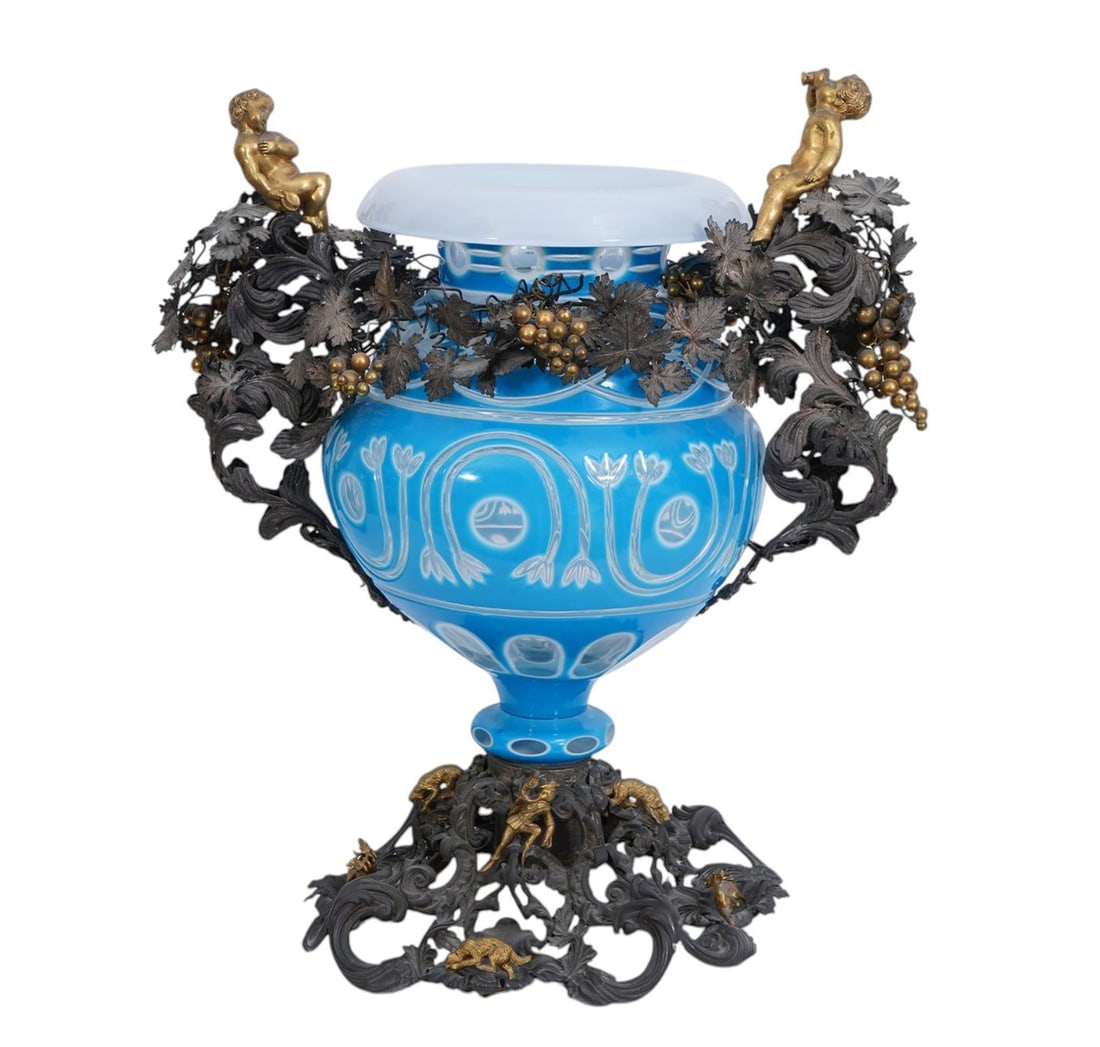 Cut to Clear Glass Centerpiece Vase with putti and foliate Silver and Bronze metal at handles and: Cut to Clear Glass Centerpiece Vase with putti and foliate Silver and Bronze metal at handles and base. 17h x 15wide inches.