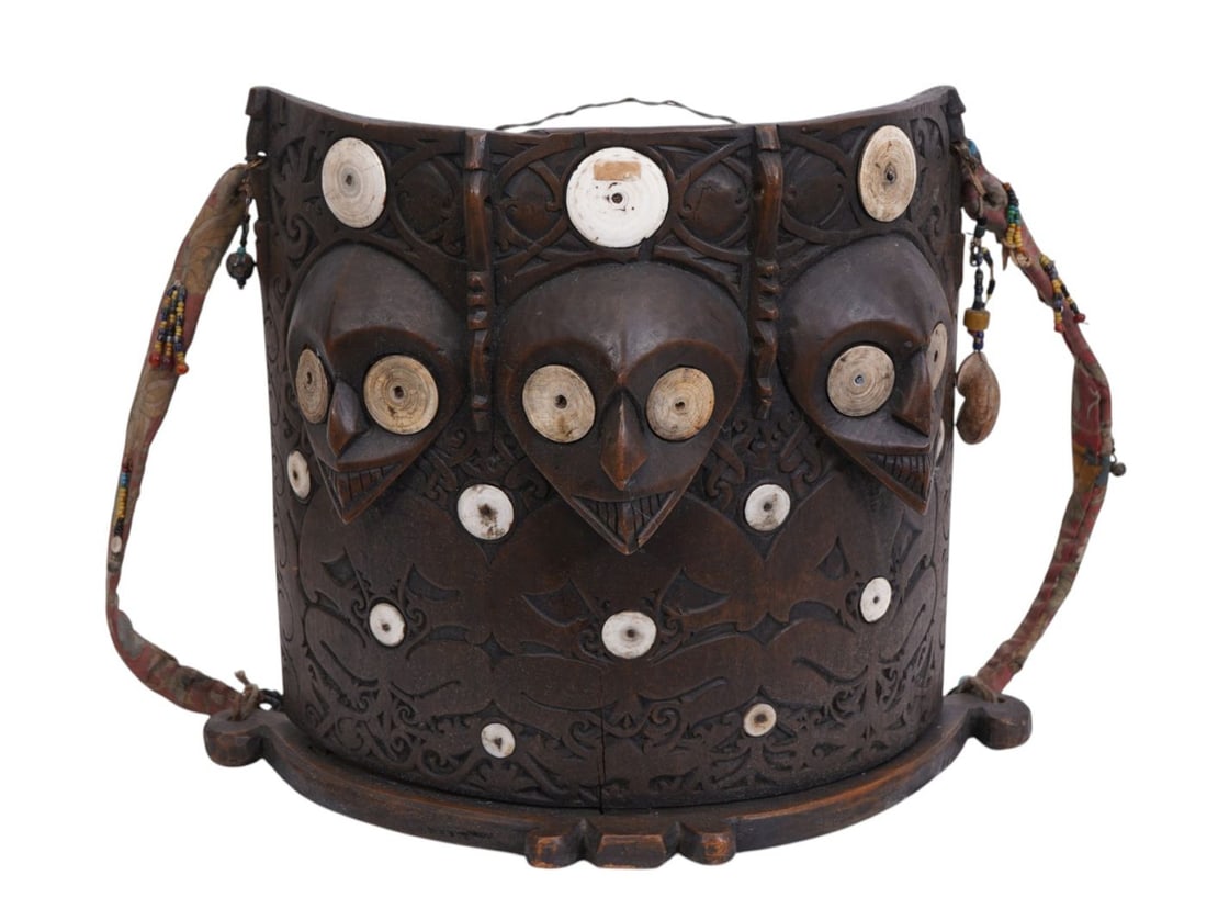 Antique tribal Dayak carved wood baby carrier featuring shell inlays, strung beads, hanging Sells,: Antique tribal Dayak carved wood baby carrier featuring shell inlays, strung beads, hanging Sells, carved wooden figures, and relief and incised geometric motifs, 13" high x 16" wide x 7" deep