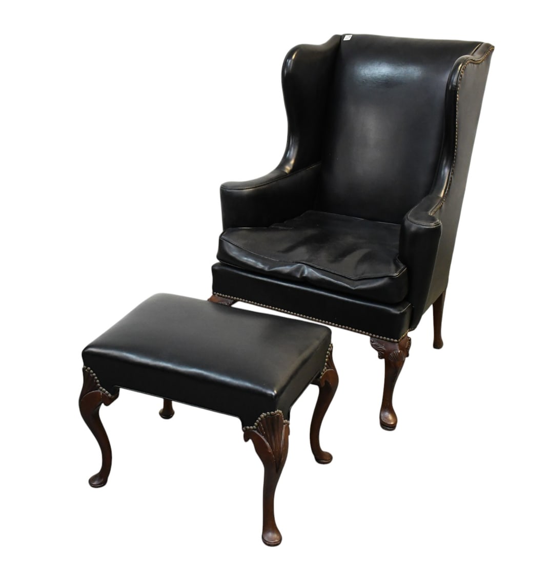Black Leather Wingback Chair with Brass Nail heads & Ottoman, 43"h x 24"w x 24"d ***If this item is: Black Leather Wingback Chair with Brass Nail heads & Ottoman, 43"h x 24"w x 24"d***If this item is not picked up by the Friday following the auction, it will be moved to offsite storage and pickup wil