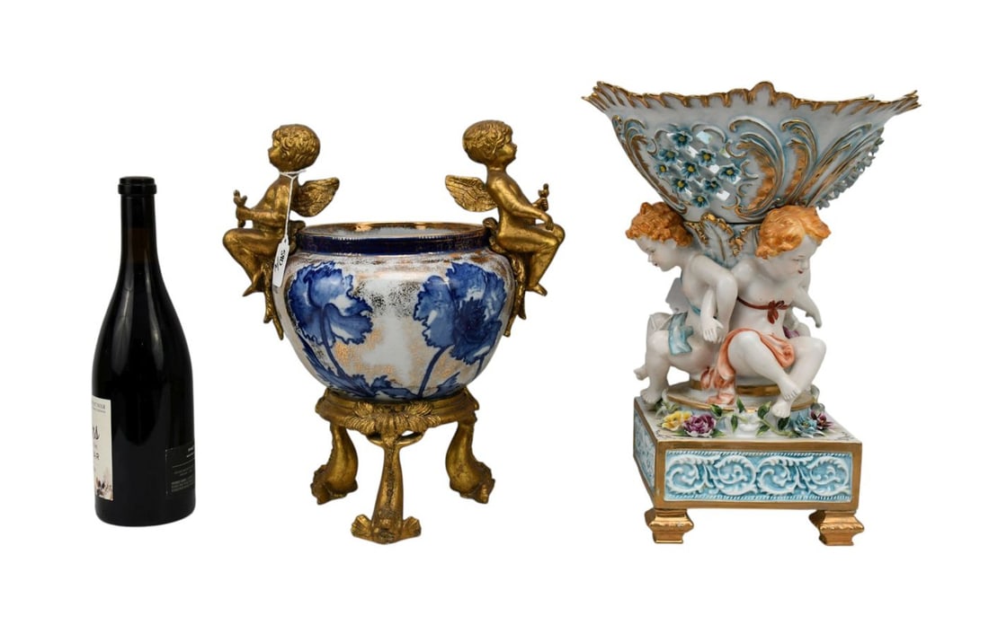 Capodimonte Porcelain Compote Sitting on 3 Cupid Supports Holding Reticulated Bowl (15"h x 11"dia): Capodimonte Porcelain Compote Sitting on 3 Cupid Supports Holding Reticulated Bowl (15"h x 11"dia) (Missing Foot) AND Porcelain Centerpiece, Blue & White with Composition Gilded Angel Handles & Base (