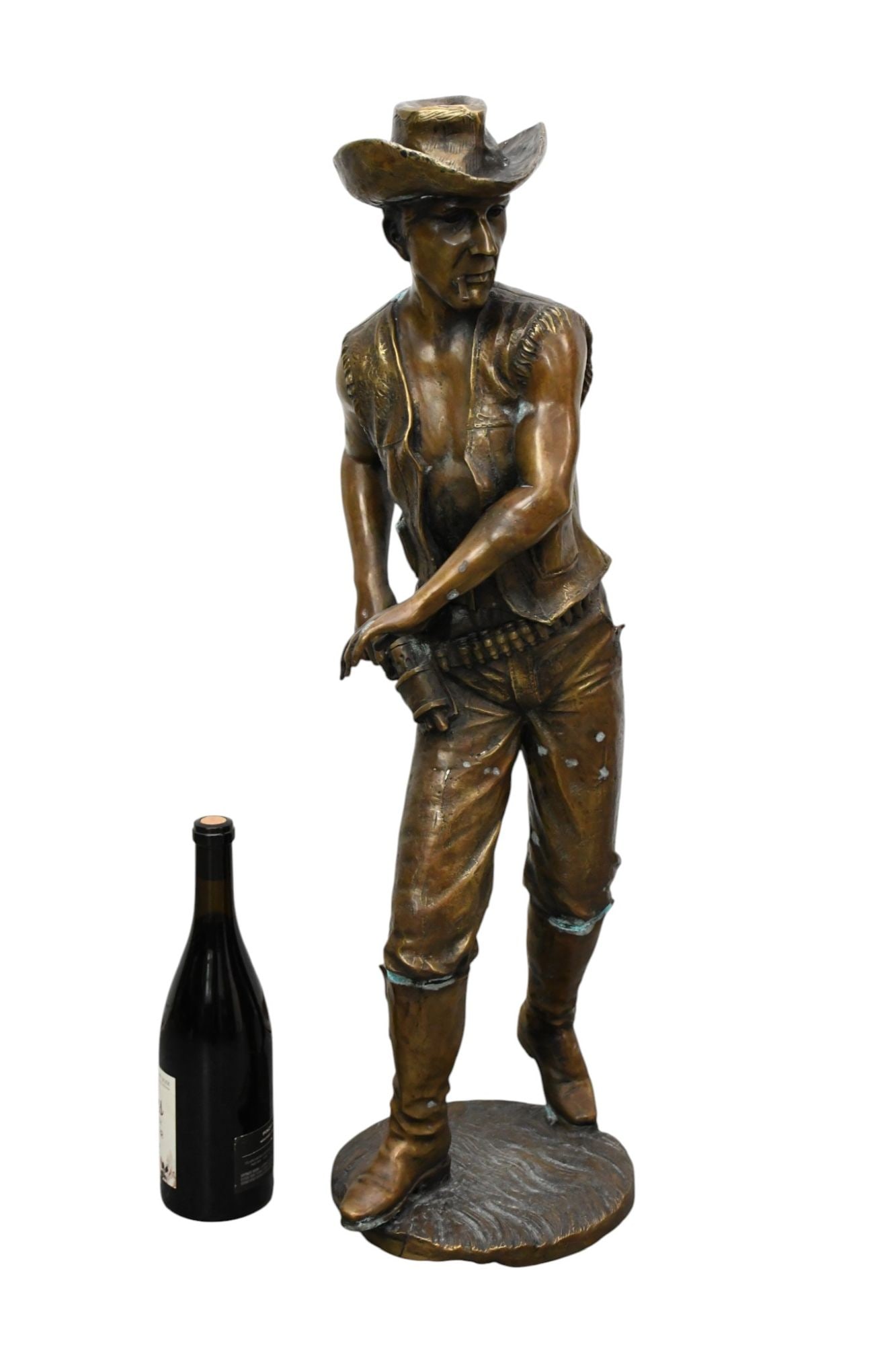 Large Standing Bronze cowboy figurine, signed Zhi Qiang, wearing a wide-brimmed hat and vest,: Large Standing Bronze cowboy figurine, signed Zhi Qiang, wearing a wide-brimmed hat and vest, standing on a round base, 32 x 9 inches.