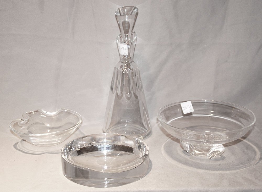 4 signed clear glass pcs; Steuben bowl (3"h x 7: 4 signed clear glass pcs; Steuben bowl (3"h x 7 3/4"dia), small Steuben shaped bowl (2"h x 6"w) AND Baccarat decanter (11 1/2"h), Baccarat ashtray with chip (1 1/2"h x 7"dia)