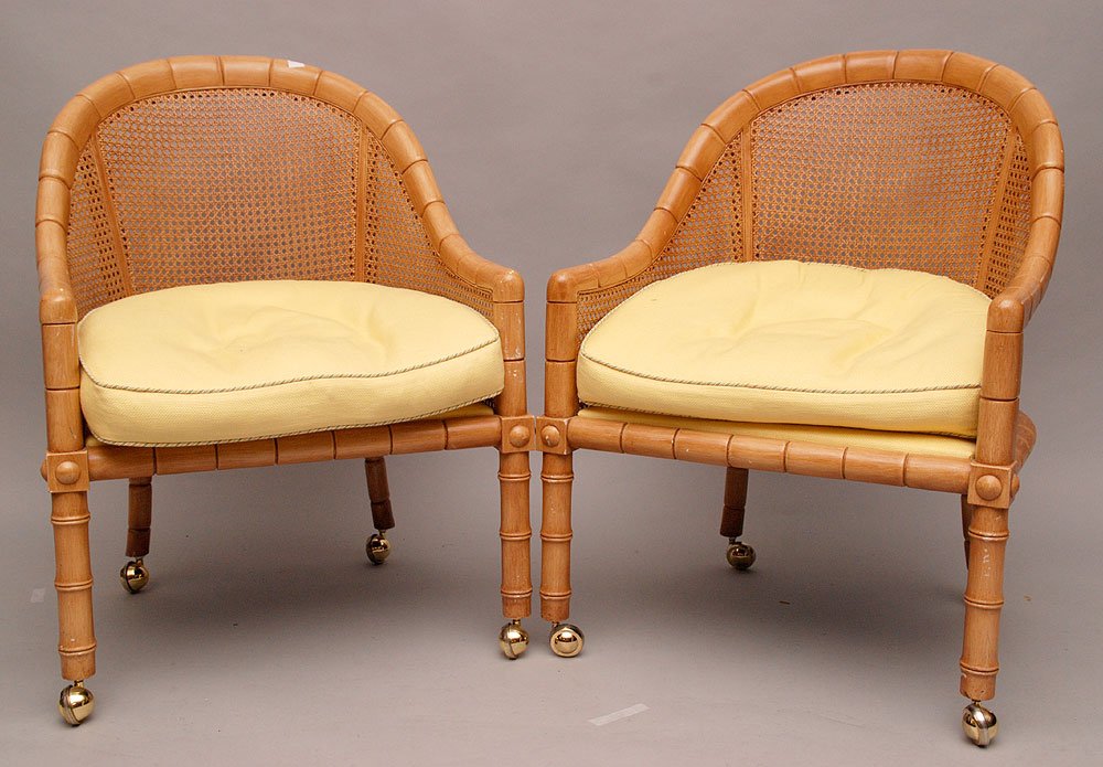 Pair lightwood caned arm chairs on wheels: Pair lightwood caned arm chairs on wheels