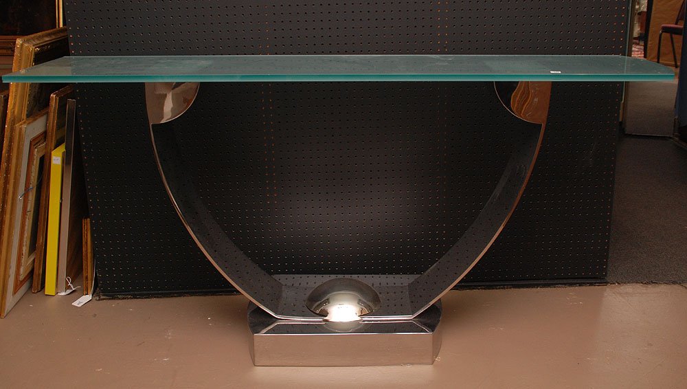 Chromed metal and glass console table, late 20th c,: Chromed metal and glass console table, late 20th c, rectangular glass top with one curved end, raised on a pair of chromed metal supports ending in conforming base, 34"h x 68"w x 18"d