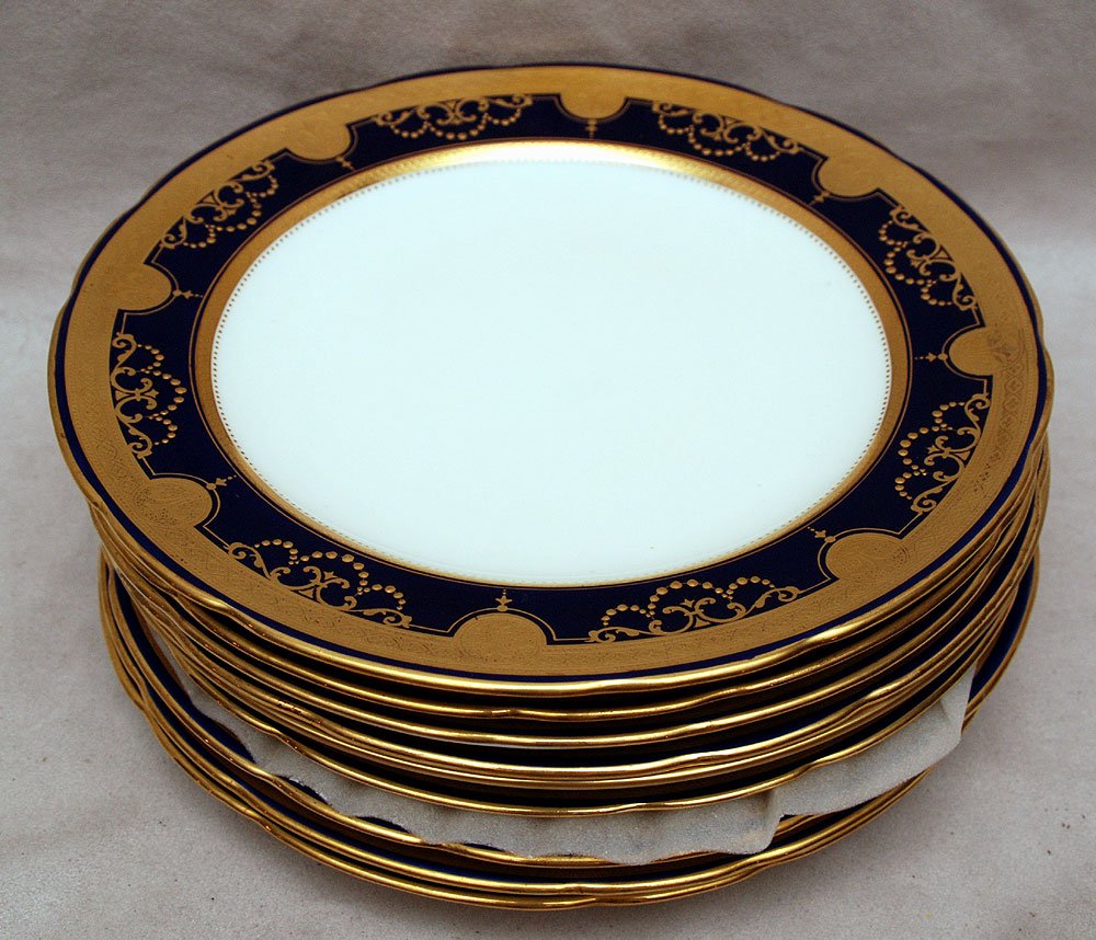 8 Minton plates,Tiffany & Co. cobalt rims: 8 Minton plates, Tiffany & Co. cobalt rims with raised gold design, cream centers, 8 1/2"dia (one has crack)