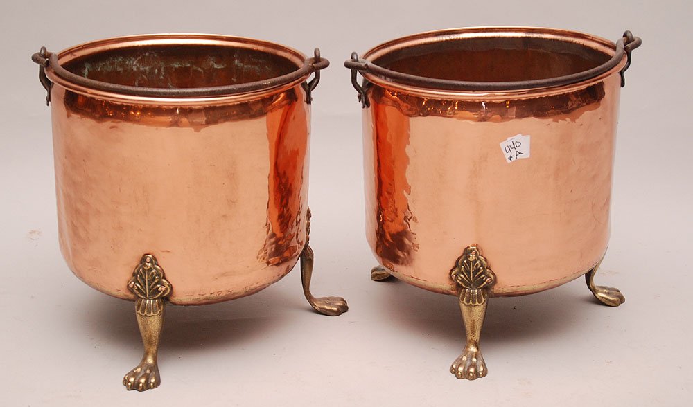Pair Antique hand hammered copper buckets/planters with: Pair Antique hand hammered copper buckets/planters with 3 brass paw feet and iron bale handle, 13"h x 12"dia