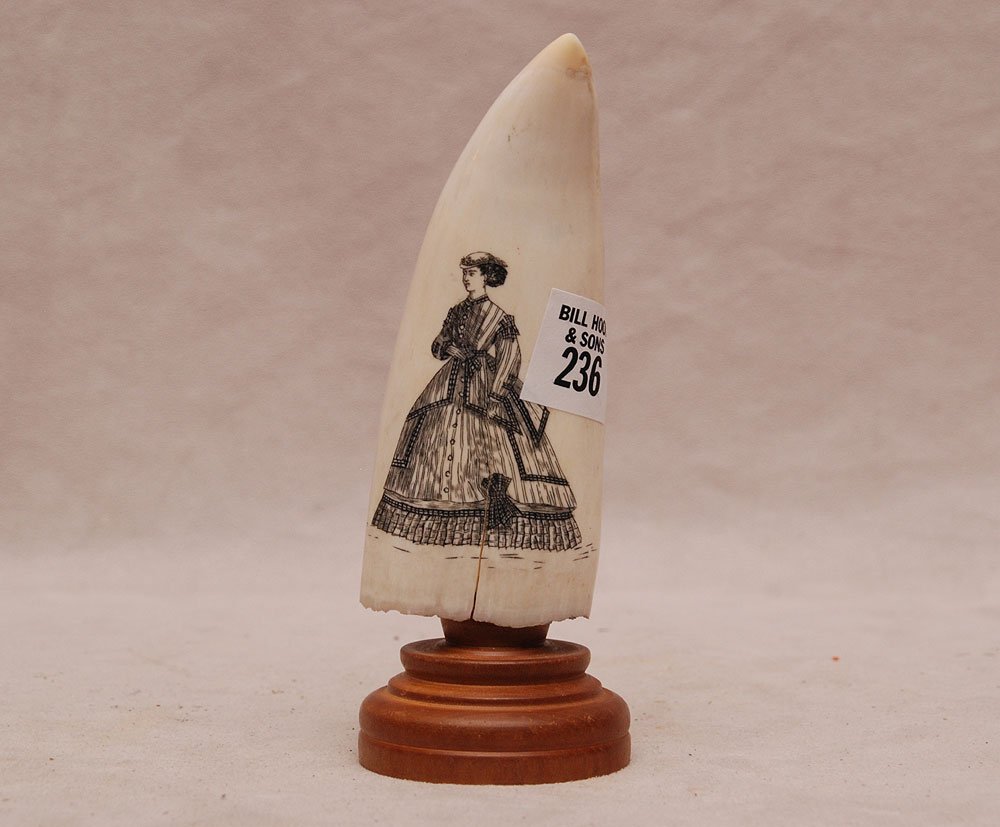 Genuine Large Vintage Scrimshaw Whale's Tooth with stan: Genuine Large Vintage Scrimshaw Whale's Tooth with stand. Depicting Whale Fishermen on front and a Victorian Lady on back. Good size 5 1/2" x 2 1/4" and 6 1/2" w/stand.