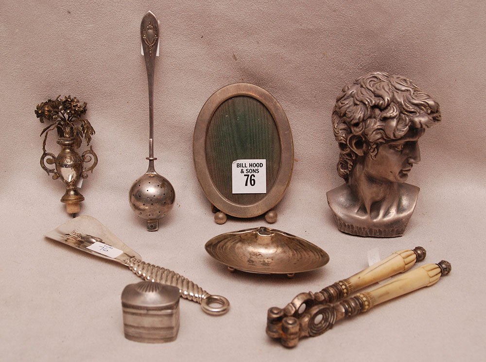 Lot of 9 novelty pieces; 4 sterling pieces (bust,: Lot of 9 novelty pieces; 4 sterling pieces (bust, frame, tea ball strainer, shell dish, shoehorn, unique stopper, pill box and nutcracker