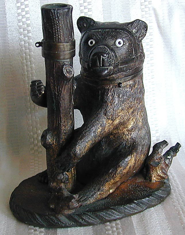19thc Bronze Bear Inkwell Pen Holder Amusing bronze: 19thc Bronze Bear Inkwell Pen Holder Amusing bronze bear inkwell and pen holder depicting a sitting bear against a log; glass eyes; 5.5"H x 5"W; white glass inkwell with chip.