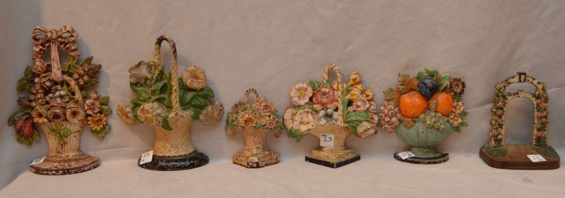 Lot of 6 antique painted doorstops, assorted sizes,: Lot of 6 antique painted doorstops, assorted sizes, floral bouquet motif