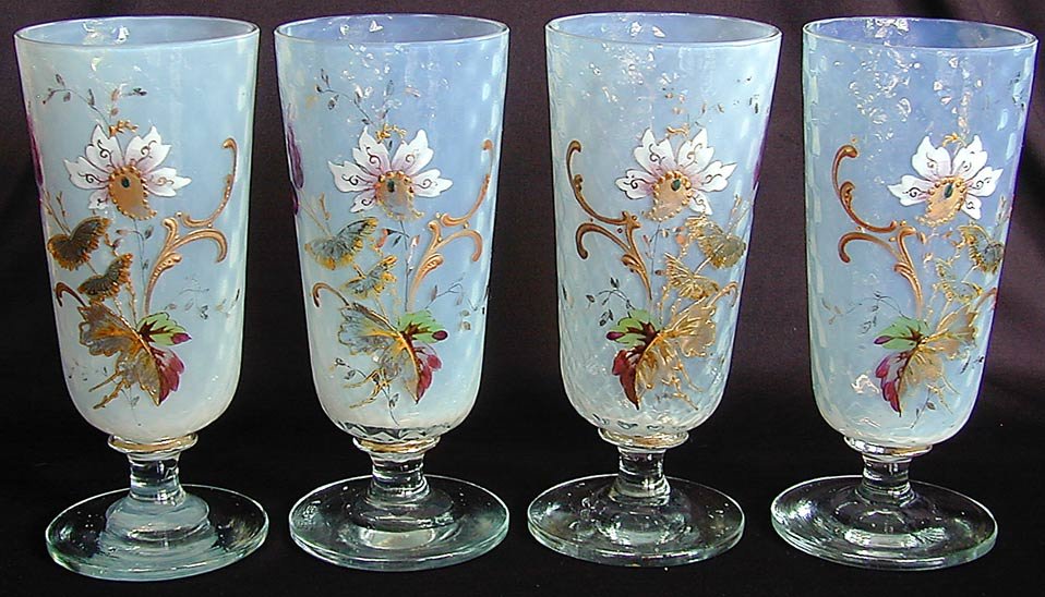 4 Enameled Opaline Crystal Stemmed Goblets Each antique: 4 Enameled Opaline Crystal Stemmed Goblets Each antique goblet with colorful hand-painted enamel exhibiting a floral and butterfly motif; polished bases; each 6.5"H; small chip to top rim of one.