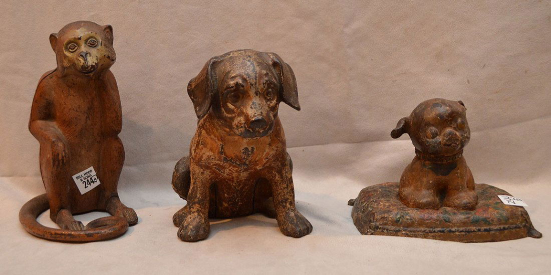 3 iron doorstops, dog on pillow (missing ear), seated: 3 iron doorstops, dog on pillow (missing ear), seated dog and seated monkey