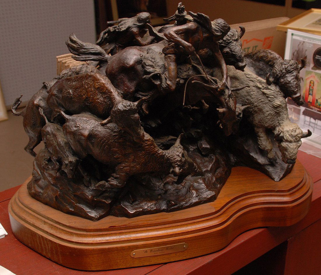 Bronze sculpture by Ken Payne Buffalo grouping: Bronze sculpture, Buffalo grouping label reads, "A Priceless Robe" signed Ken Payne on swivel platform, numbered 17/30,13"h x 23"w
