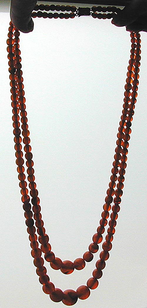 Antique Double Strand Amber Bead Necklace Comprised of: Antique Double Strand Amber Bead Necklace Comprised of round graduated translucent butterscotch color amber beads mounted with a vintage rhinestone clasp; longest strand measures 13.5”L, shortest st