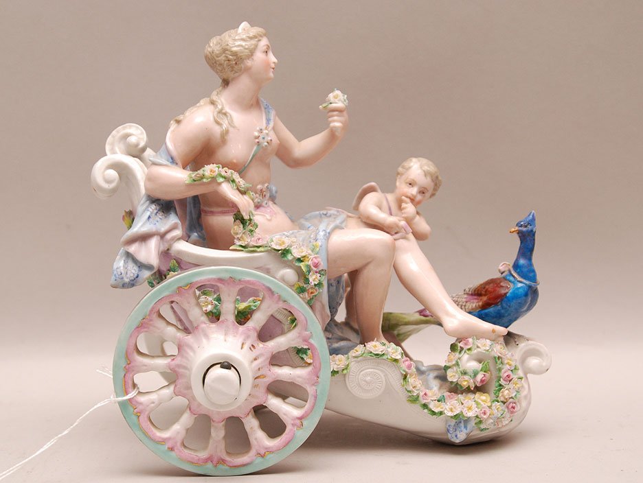 Meissen Porcelain Group depicting a woman, cherub and p: Meissen Porcelain Group depicting a woman, cherub and peacock on a chariot. Condition: the piece has a old professional repair to the head of the peacock, the cherubs wings, and shows other slight in-