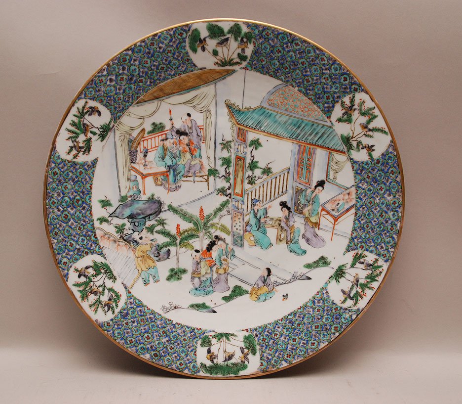 Chinese Famille Verte Porcelain Charger centered by fig: Chinese Famille Verte Porcelain Charger centered by figures in a courtyard and garden scene on a white ground. Condition: good with minor normal wear. Dia. 16 1/4"