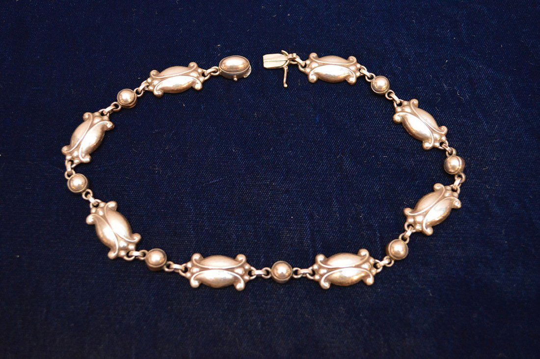 One ladies sterling silver neckpiece by Georg Jensen: One ladies sterling silver neckpiece by Georg Jensen #15, shiny ornate hammered design weighing 35.1 grams