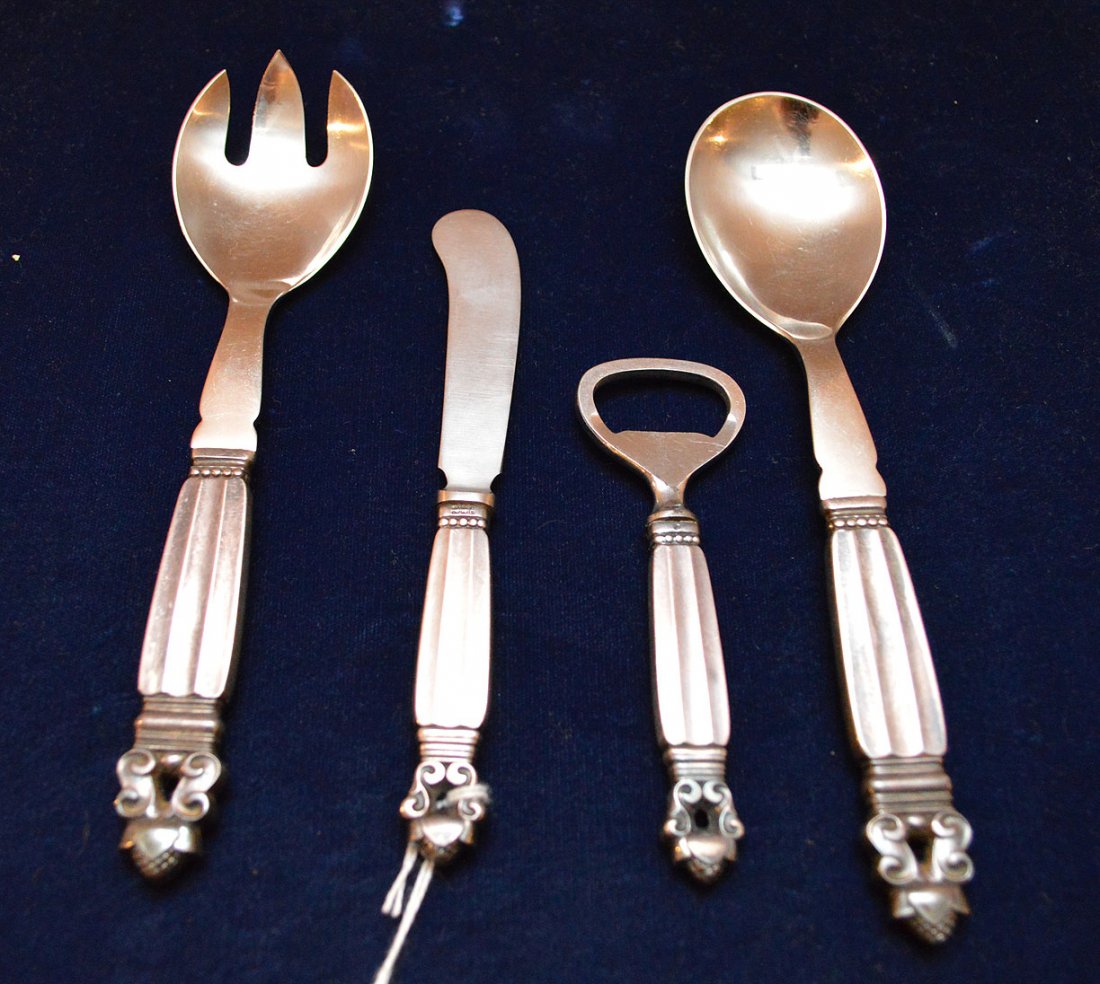 4 pieces of Georg Jensen sterling, one salad set with: 4 pieces of Georg Jensen sterling, one salad set with stainless tops (7 3/4"l), one butter spreader with a stainless blade (6 1/4"L) and one can opener with a stainless top (4 1/2"L)