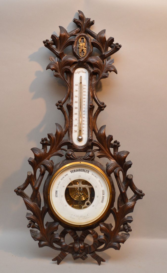Black Forest German carved wood framed thermometer and: Black Forest German carved wood framed thermometer and barometer, 33"h x 16"w