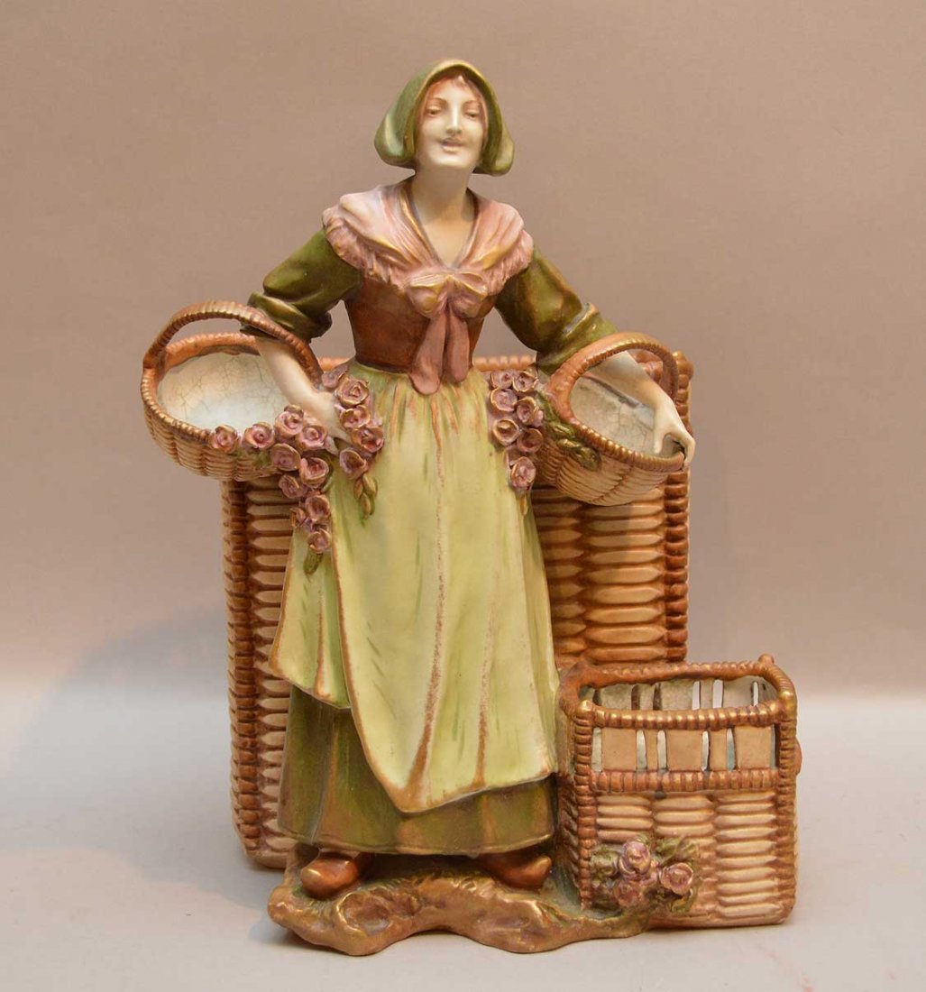 Amphora Porcelain Figural Vase with a woman holding: Amphora Porcelain Figural Vase with a woman holding baskets. Condition: some crazing on the interior of the baskets and minor normal wear. Ht. 12"