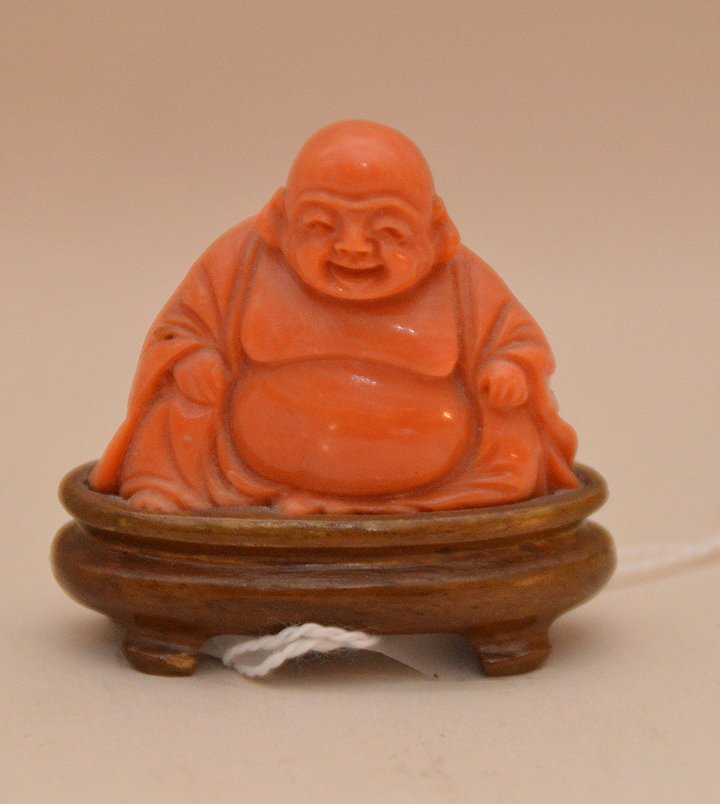 Carved coral buddha on wood stand, 1 7/8"h (1 of 3)