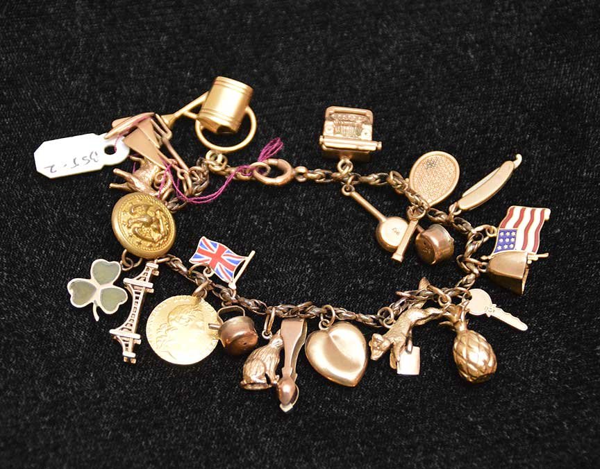Gold charm bracelet, some charms marked 14kt: Gold charm bracelet, some charms marked 14kt