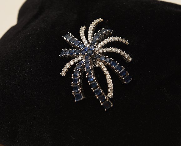 Diamond and Sapphire Pendant starburst form. 18K white: Diamond and Sapphire Pendant starburst form. 18K white gold approx. 4 cts. Sapphire and approx 3cts. Diamonds.