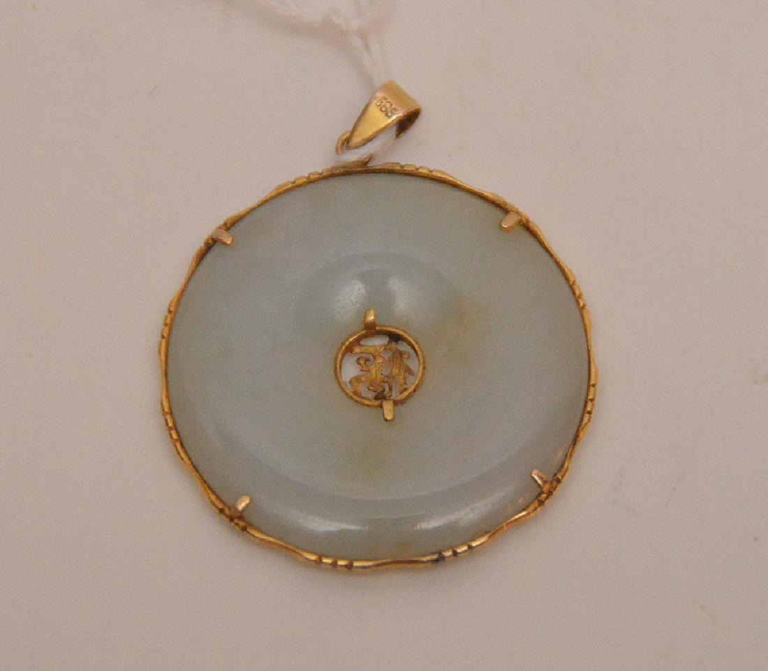 Antique White Jade Disc mounted in 14K yellow gold as a: Antique White Jade Disc mounted in 14K yellow gold as a necklace pendant. Dia. 1 3/4"