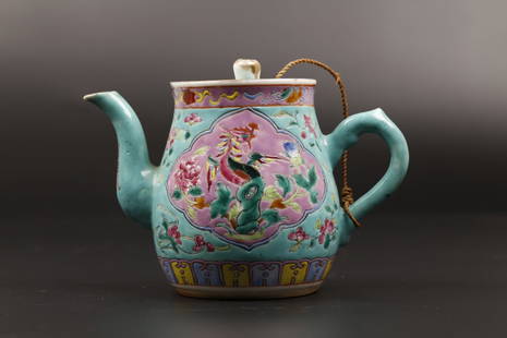 A Famille Rose Porcelain Teapot: The teapot is marked 'TongZhi' with phoenix patterns painted in reserves. Overall turquoise toned. H: 11.7cm. W: 17cm.