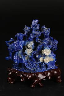 A Lapis Lazuli Carved Display Piece: This rare carved lapis lazuli stone is rich in color, displaying a deep royal blue with minor white and gold dots. This piece is carved into a two goddesses sitting in a large tree. Wooden base includ