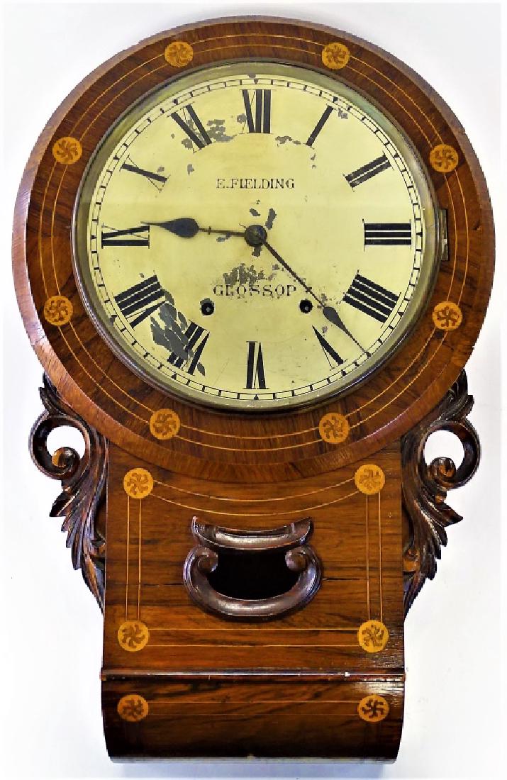 19TH C. ENOCH FIELDING INLAID MAHOGANY WALL CLOCK: Early to Mid 19th century inlaid Mahogany case wall clock by Enoch Fielding, Glossop, England. With large circular Tin dial, enameled with roman numerals. The Mahogany body case in two parts, with spa