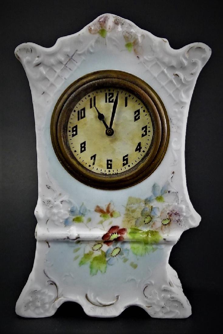 ANTIQUE NEW HAVEN PORCELAIN CASE ALARM CLOCK: Antique Porcelain case alarm clock by New Haven Clock Co., New Haven, CT. Comprised of a bone white Porcelain case decorated in relief with lattice work, scrolled rocaille, and floriate spandrels in t