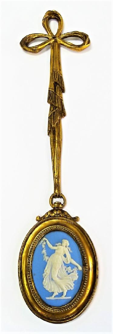 ORMOLU BRONZE MOUNTED WEDGWOOD WALL PLAQUE: Antique Ormolu Bronze mounted Wedgwood wall plaque. The mount designed in Ribbon & Medallion motif, set to the center with an oval shaped Wedgwood Jasperware plaque. Holds impressed Wedgwood mark en v