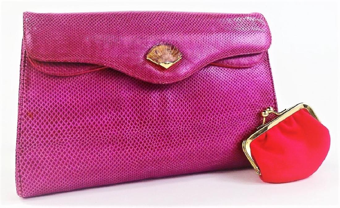 JUDITH LEIBER CERISE KARUNG SNAKESKIN CLUTCH: Judith Leiber Cerise Karung Snakeskin clutch handbag. With goldtone hardware and applied Crystal clasp in the form of a Sea Shell. Has one exterior open slot pocket. The front flap snap closure opens
