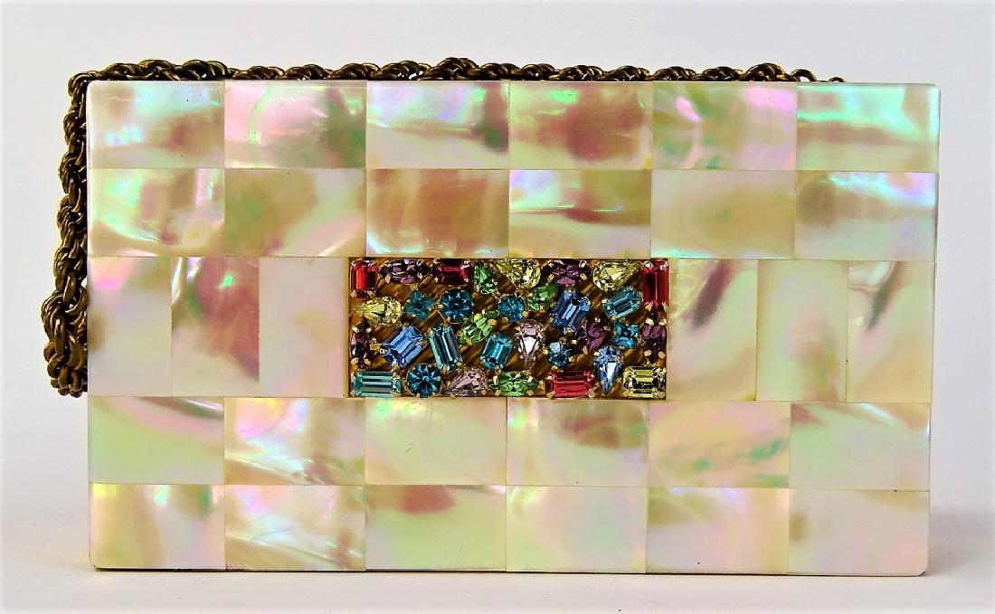 DECO EVANS JEWELED GOLDTONE MINAUDIERE CASE: Deco period Evans jeweled goldtone metal minaudiere case. Hinged lid with Mother of Pearl style panel jeweled with simulated stones. Has interior mirror, powder well, coin dispenser, and others. Measu