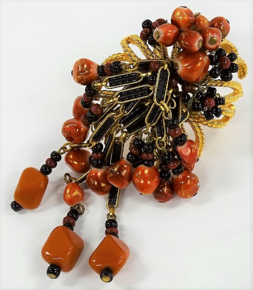 HATTIE CARNEGIE BROWN AND BLACK DANGLE BROOCH: Consists of a beautiful design w/ gold tone and dangling stones. Shipping to be $15 US. We will combine w/ price.