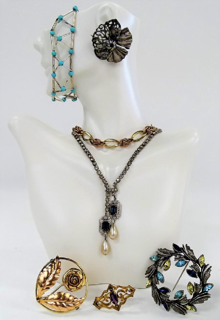 LARGE LOT OF COSTUME JEWELRY: To include a 12K GF floral circle pin, an Art Deco 12K GF two tone oval link knot bracelet, a unique Ralph Lauren silver tone w/ blue bead bracelet, a Belle Epoque style sterling w/ clear and blue rhi