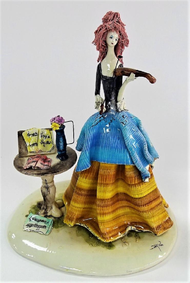 VINTAGE ITALIAN FIGURINE WOMAN PLAYING VIOLIN: Vintage Italian porcelain grouping of a woman playing violin. Measures approx 10" tall. Will not ship can refer local shippers.