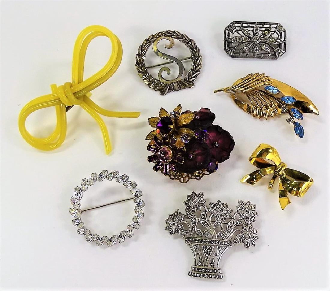LARGE LOT OF COSTUME PINS: To include a Deco sterling German Marcs basket pin, a Krementz 14K GF rhinestone circle pin, an Edwardian rectangle pin, a DeMario purple pansy pin, a sterling "S" circle pin, a yellow celluloid bow p