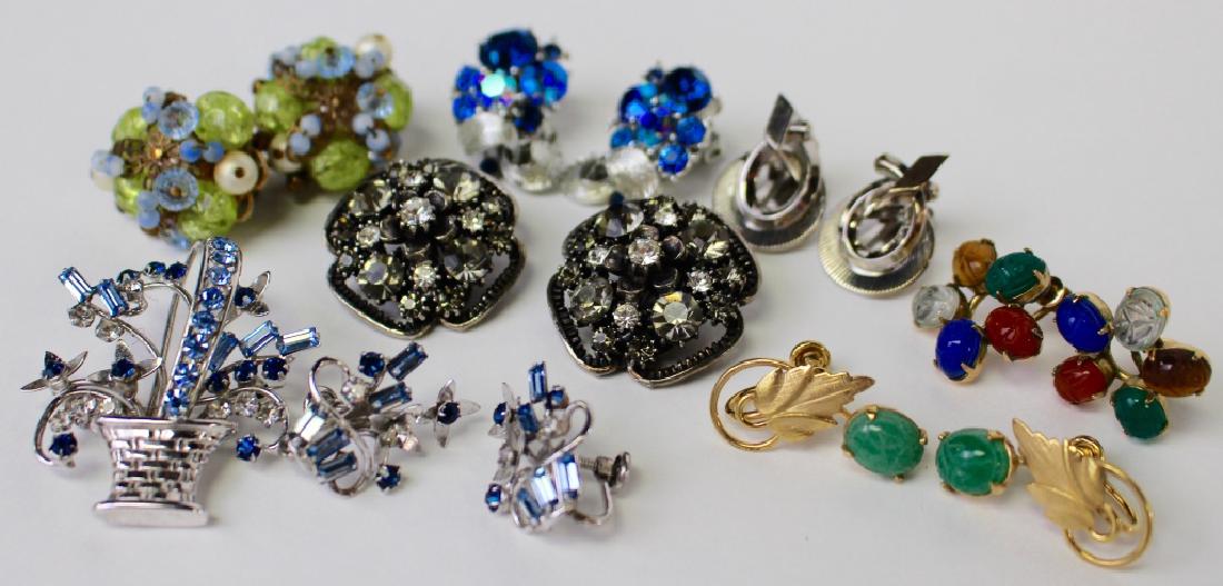 LARGE LOT OF COSTUME EARRINGS: To include a pair of Florenza rhinestone earrings, a pair of Alice Caviness rhinestone and faux pearl clip earrings, a pair of Carl Art rhinestone floral screwback earrings w/ matching basket pin, a p