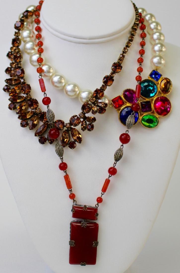 FASHIONABLE LOT OF COSTUME NECKLACES: To include a Czech glass carnelian color necklace, an unsigned Regnecy faux topaz necklace, and a Ben Amon faux pearl w/ large colored stone necklace. Shipping to be $15 US. We will combine w/ price.