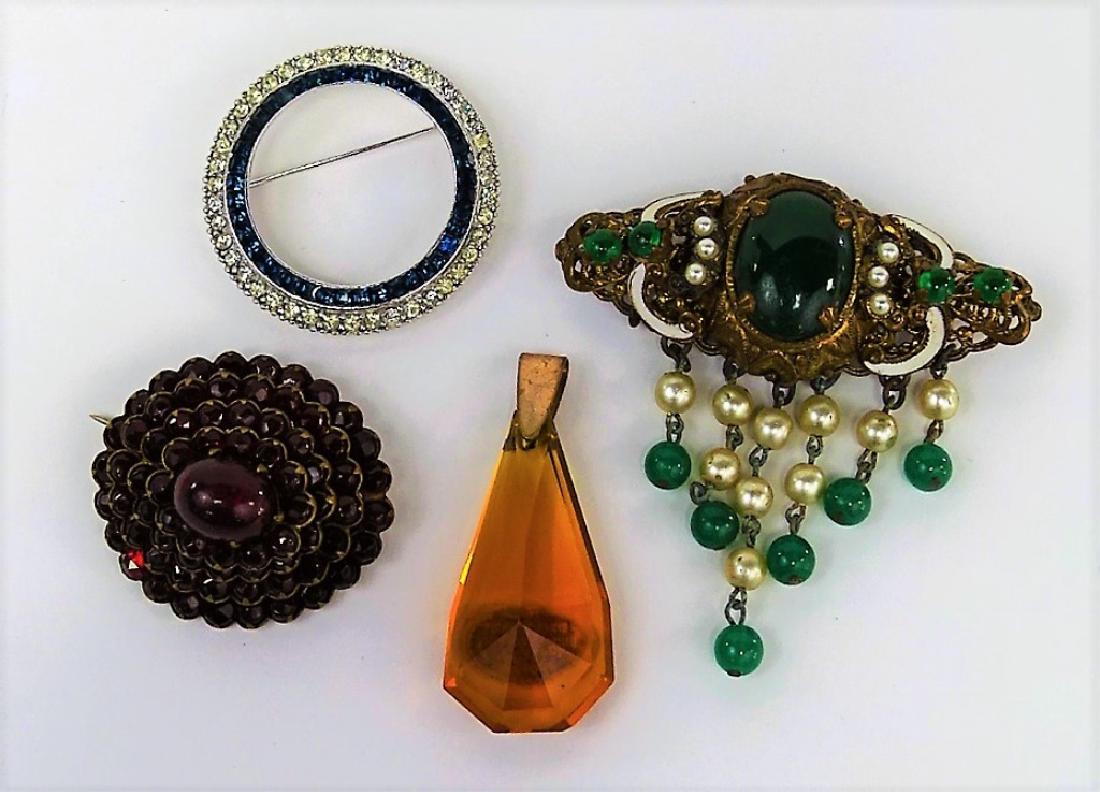 SPECTACULAR LOT OF CZECH COSTUME PINS/PENDANT: To include a Czech faux pearl and green glass pin, a Czech red stone oval pin, a Czech faux topaz pendant, and to include a Deco Ciner black and white circle pendant. Shipping to be $15 US. We will co