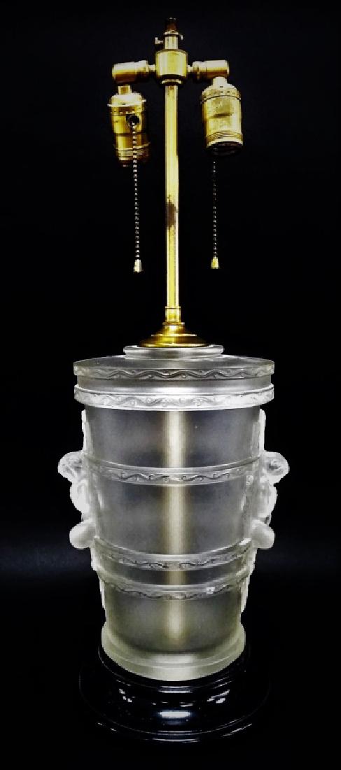 VINTAGE GLASS LEVITON LAMP FIXTURE: This lot includes a Leviton glass lamp fixture with a depiction of a baby boy on the front and back. The item measures approximately H 24" x W 8". Contains a slight chip on the side. We will not ship 